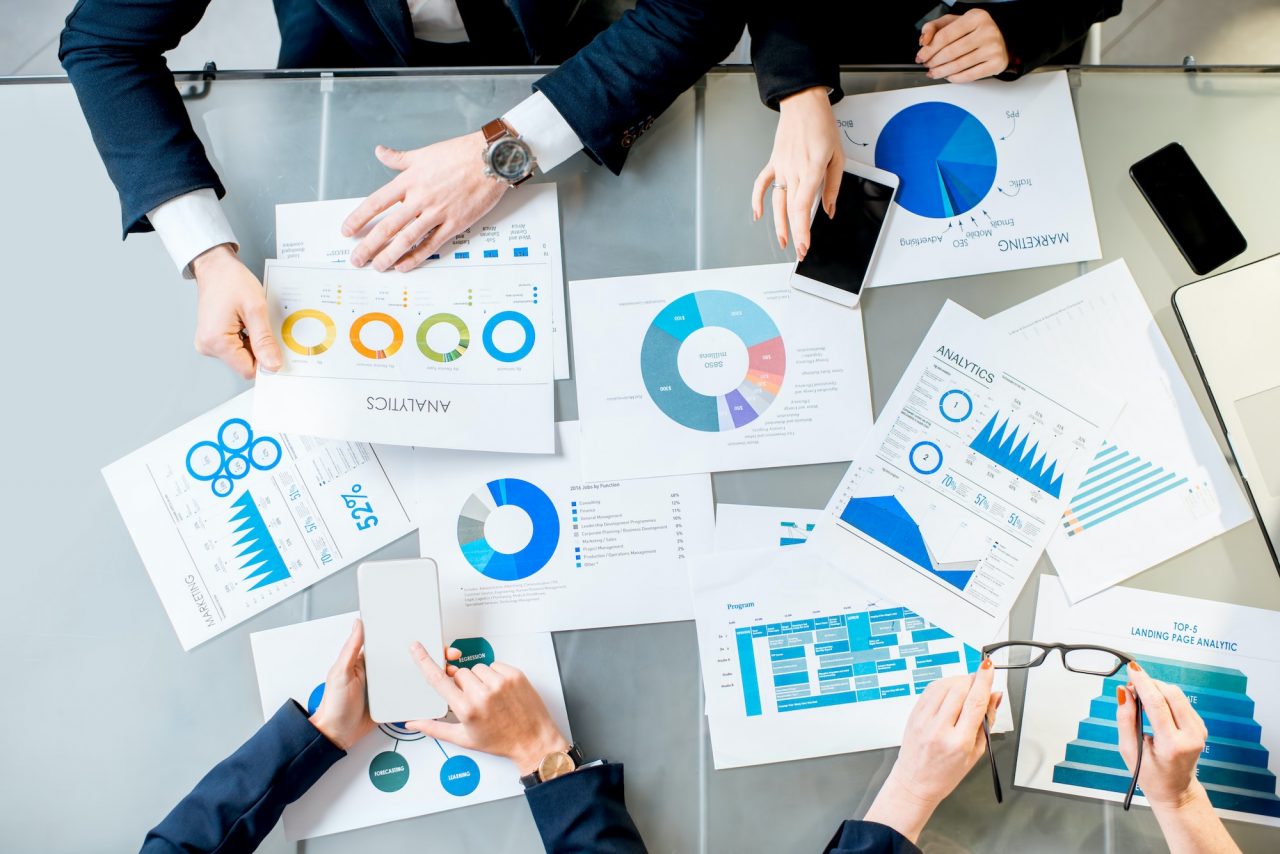 San Diego CEOs analyzing business growth charts and scaling metrics to increase enterprise value and profitability through collective intelligence.